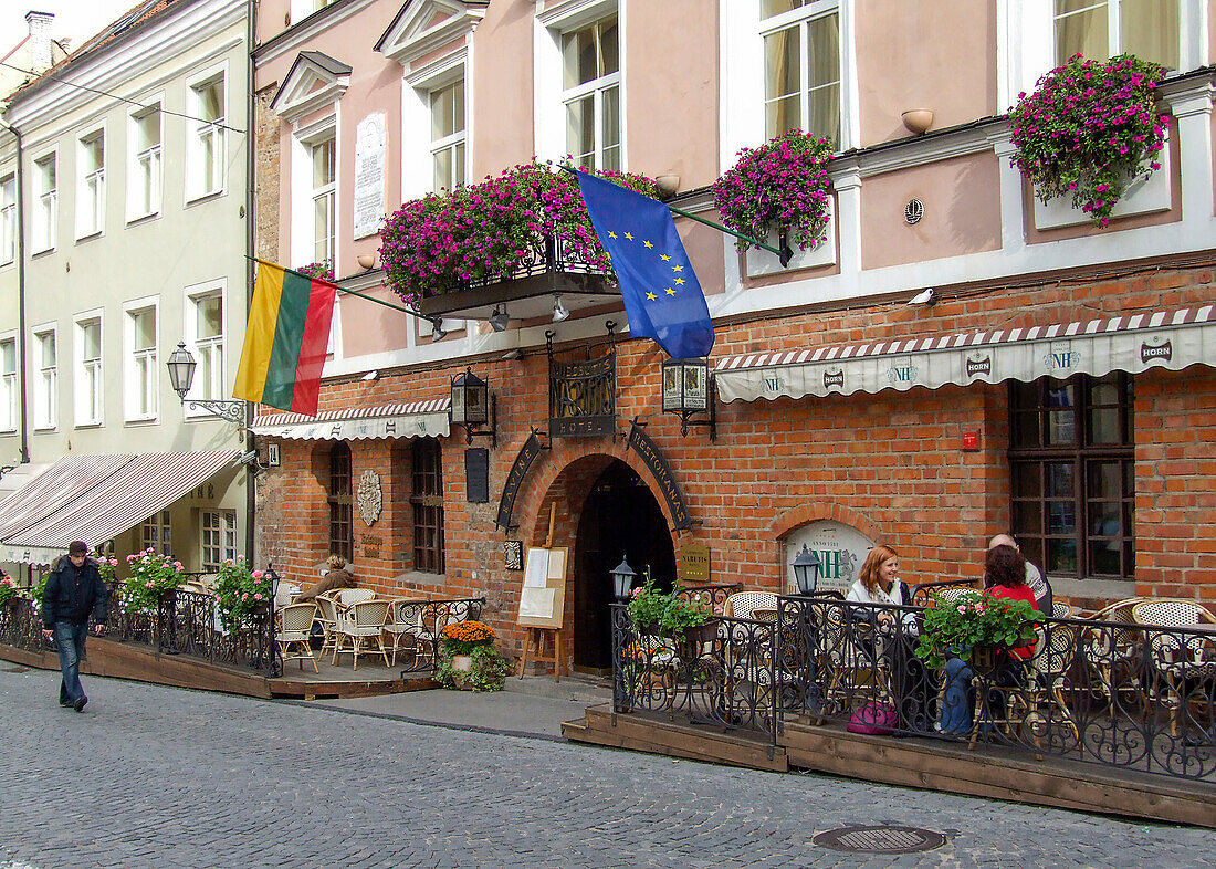 A sidewalk cafe and hotel on Pilies Street in the historic Old Town of Vilnius, Lithuania. A UNESCO World Heritage Site.