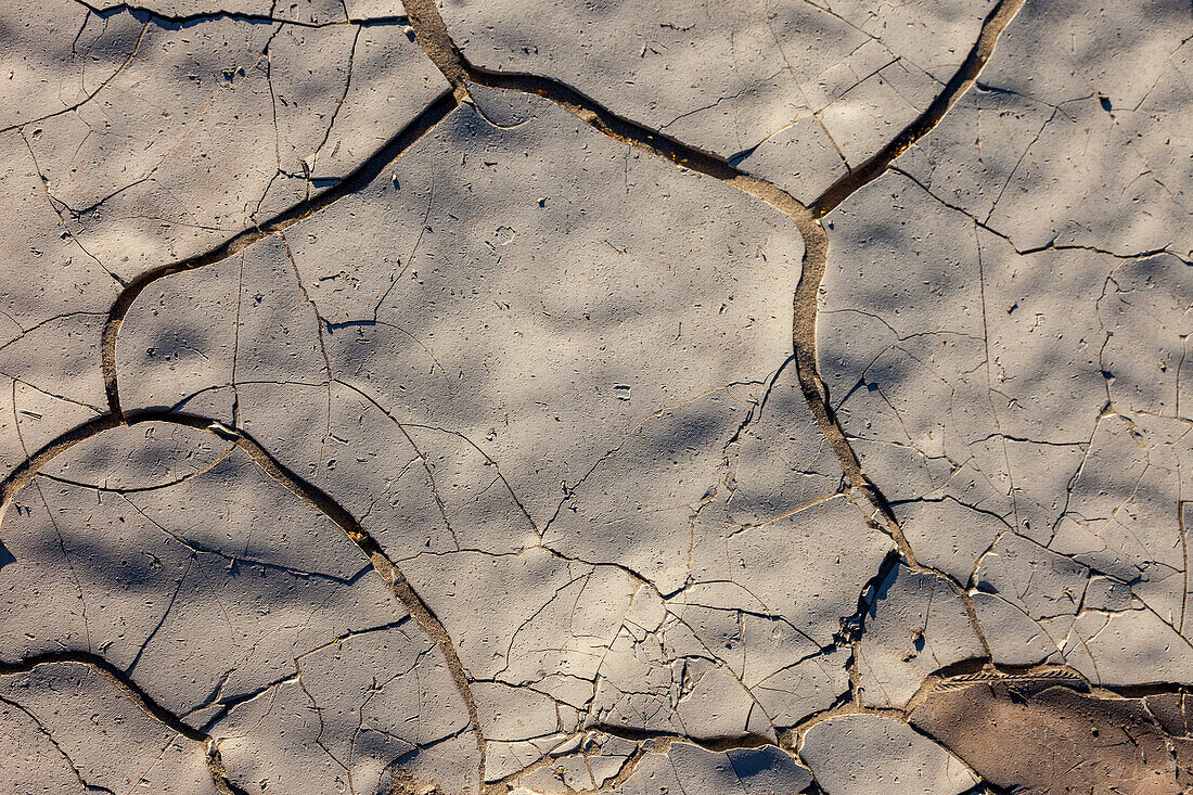 Cracks in the mud of a dry lake bed near Stovepipe Wells in Death Valley National Park in the Mojave Desert in California.