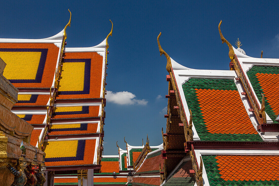 Dachdetail von Gebäuden am Tempel des Smaragdbuddhas im Grand Palace Komplex in Bangkok, Thailand. Der Ho Phra Monthien Tham ist links zu sehen.
