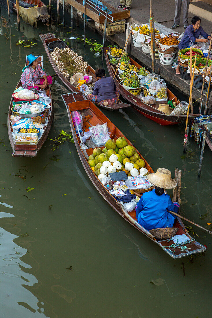 Thai vendors on their boats in the Damnoen Saduak Floating Market in Thailand.