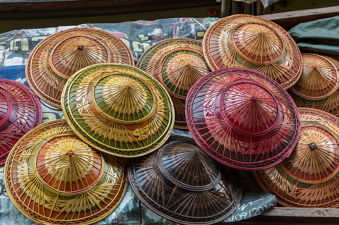 Traditional Thai hats for sale in the Damnoen Saduak Floating Market in Thailand.