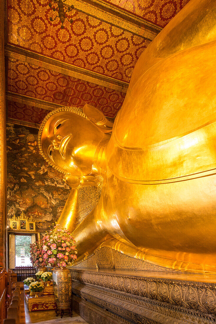 The giant Reclining Buddha statue, gilded with gold leaf, in the Wat Pho Temple in Bangkok, Thailand.