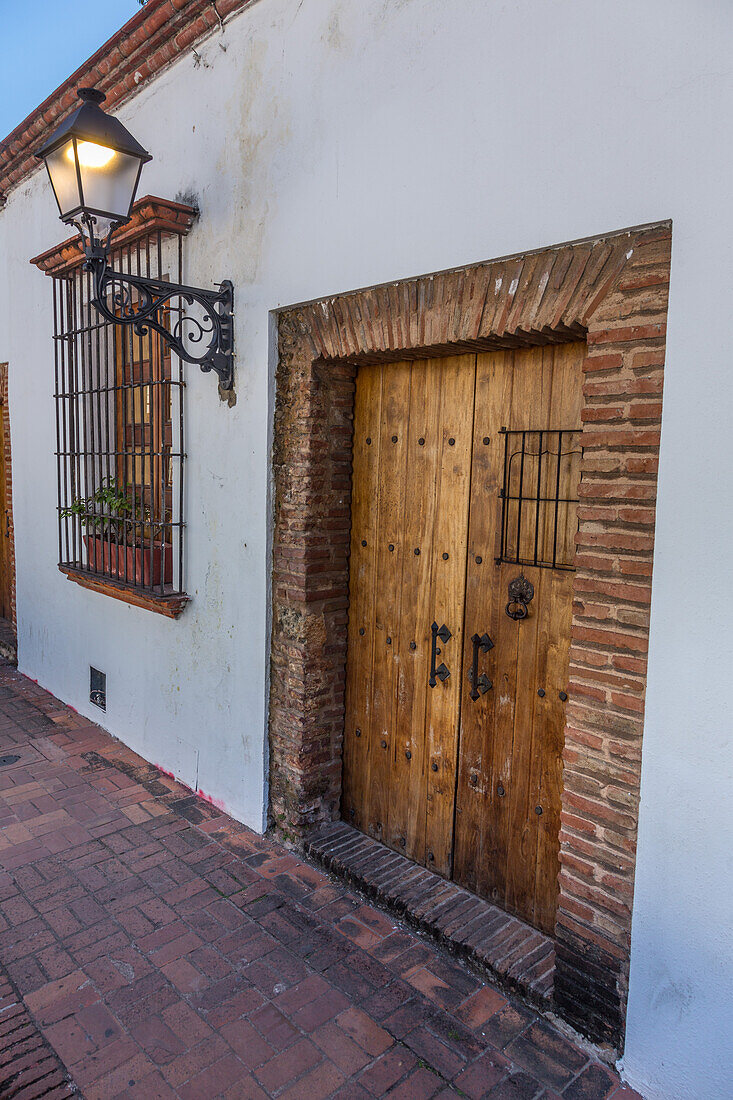 Wooden doorway in an old colonial building on Padre Billini Street, Colonial City of Santo Domingo, Dominican Republic. A UNESCO World Heritage Site.