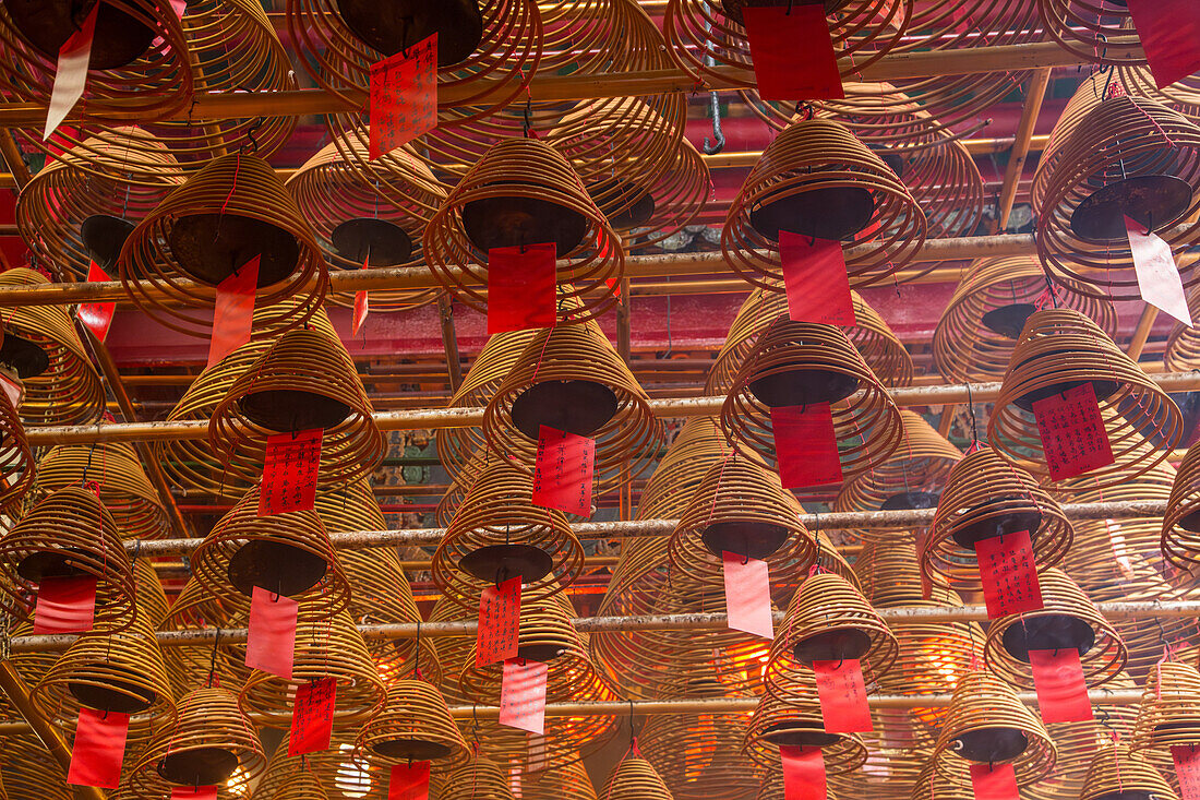 Burning incense coils send prayers to heaven in the Man Mo Temple, a Buddhist temple in Hong Kong, China.