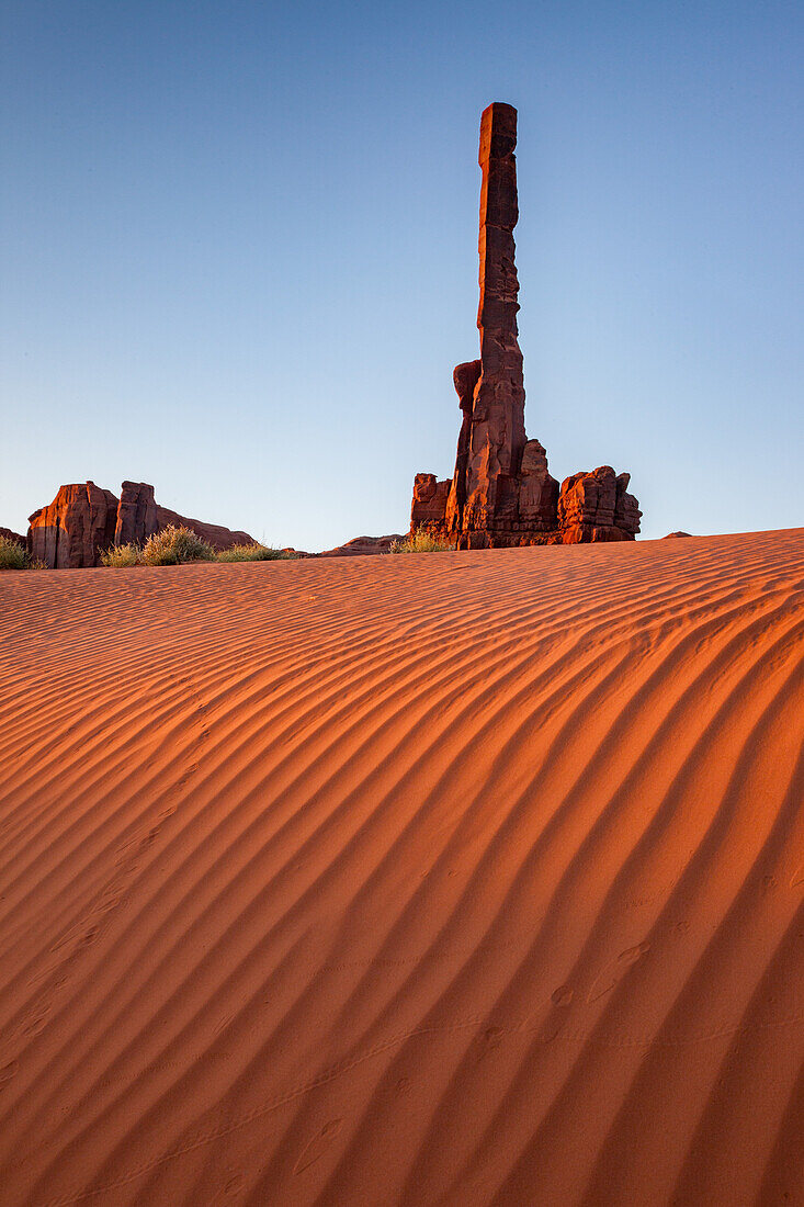 The Totem Pole with rippled sand in the Monument Valley Navajo Tribal Park in Arizona.