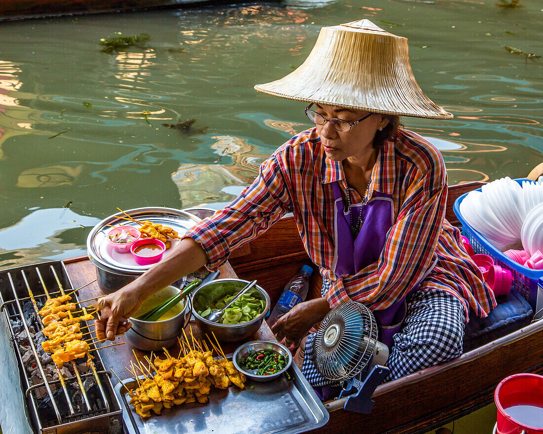 A Thai woman on her floating kitchen boat in the Damnoen Saduak Floating Market in Thailand.