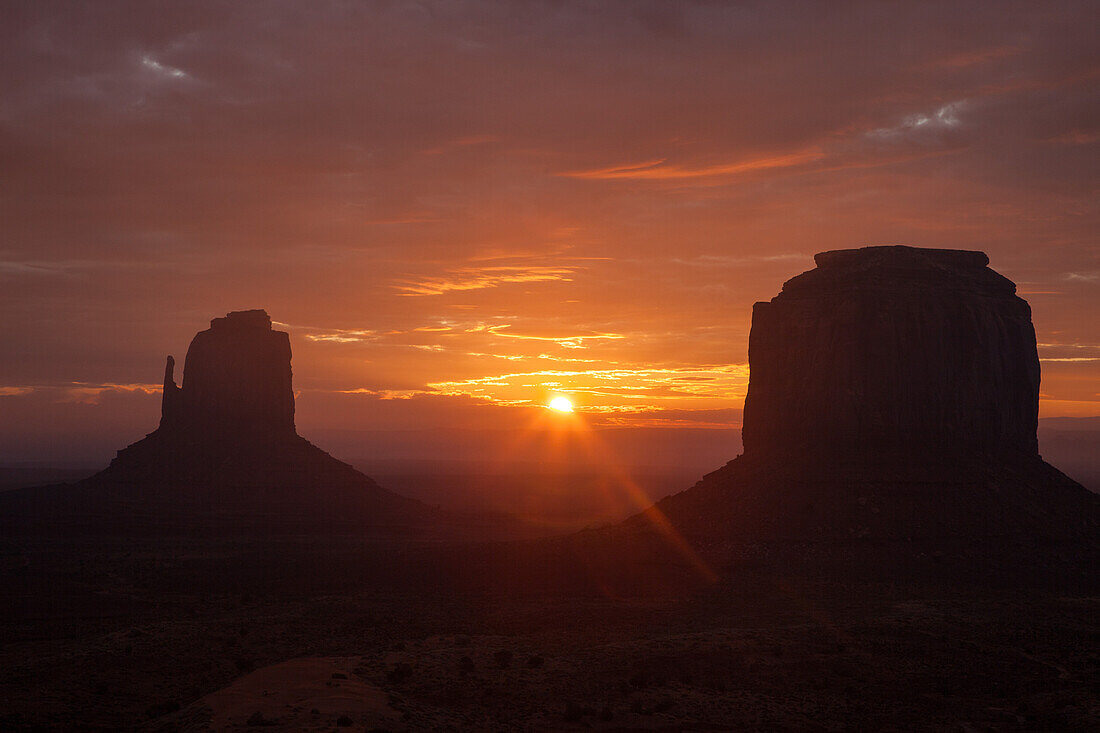 Sunrise between the East Mitten & Merrick Butte in the Monument Valley Navajo Tribal Park in Arizona