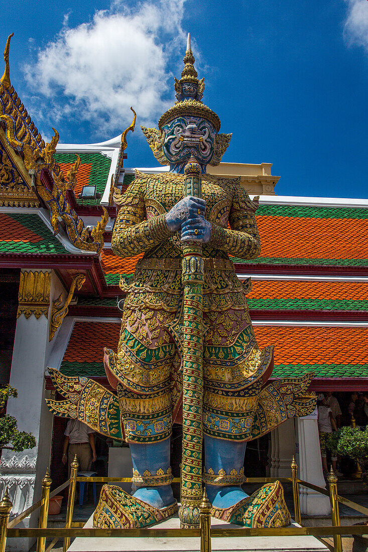 A yaksha guardian statue at the Temple of the Emerald Buddha complex in the Grand Palace grounds in Bangkok, Thailand. A yaksha or yak is a giant guardian spirit in Thai lore.