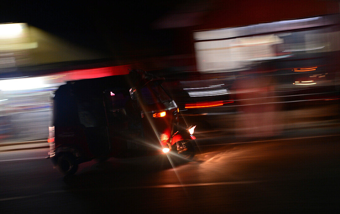 Moving tuk tuk at night, Sri Lanka