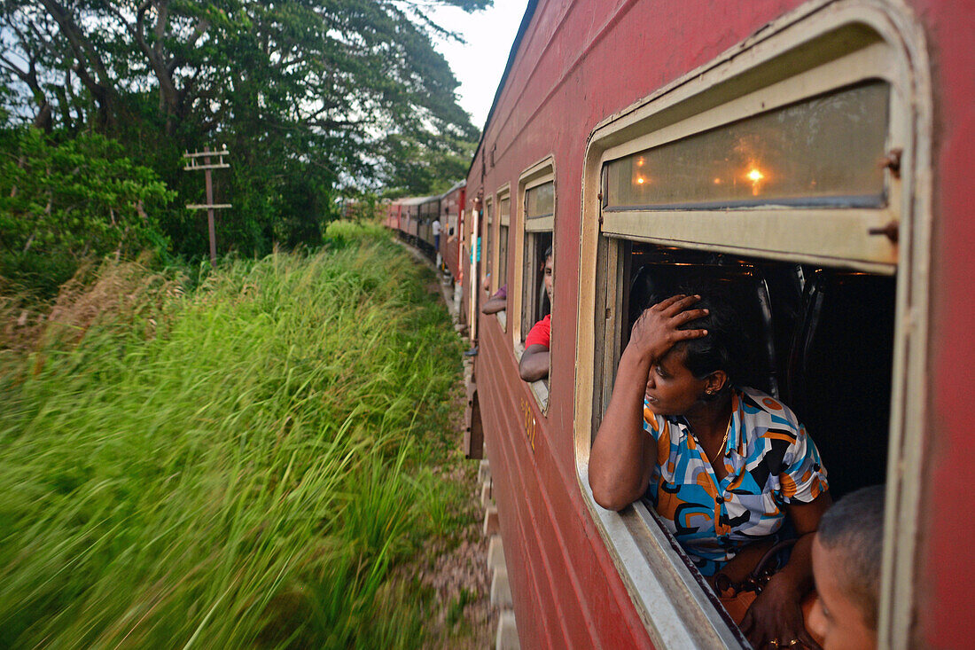 People looking through open train window, Sri Lanka