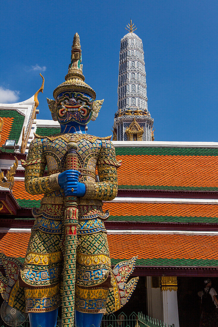 A yaksha guardian statue at the Temple of the Emerald Buddha complex in the Grand Palace grounds in Bangkok, Thailand. A yaksha or yak is a giant guardian spirit in Thai lore. Wirunhok is this guardian's name.