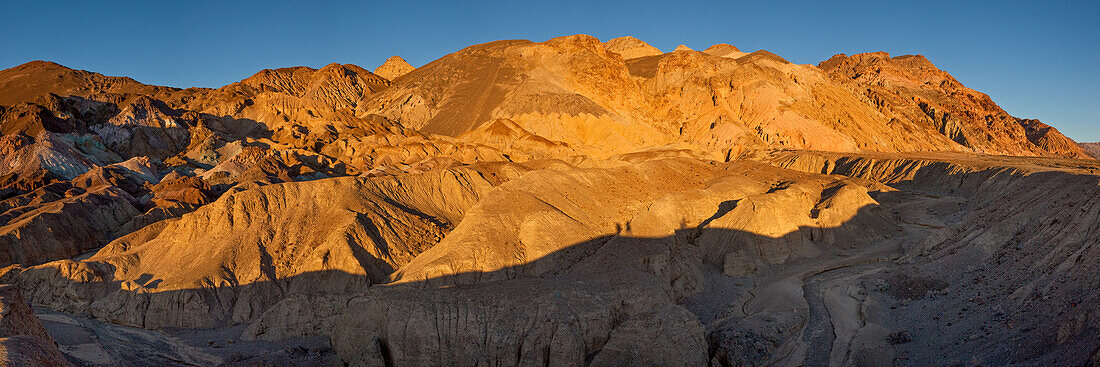 Colorful eroded badlands of the Artist's Palette at sunset in Death Valley National Park in California.