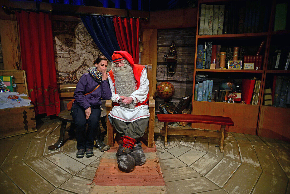 Young woman meeting Santa Claus. Official Hometown of Santa Claus in Rovaniemi, Lapland, Finland