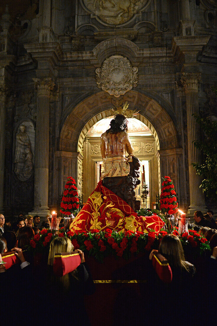 Holy week procession enters Colegiata de San Justo y Pastor in Granada, Spain