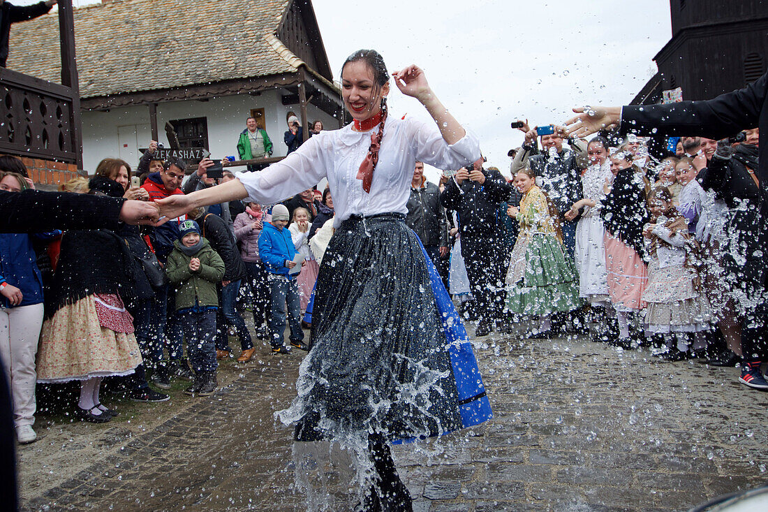 Water spraying ritual, traditional costumes and folk traditions at Easter Festival in Holl?k?, UNESCO World Heritage-listed village in the Cserh?t Hills of the Northern Uplands, Hungary.