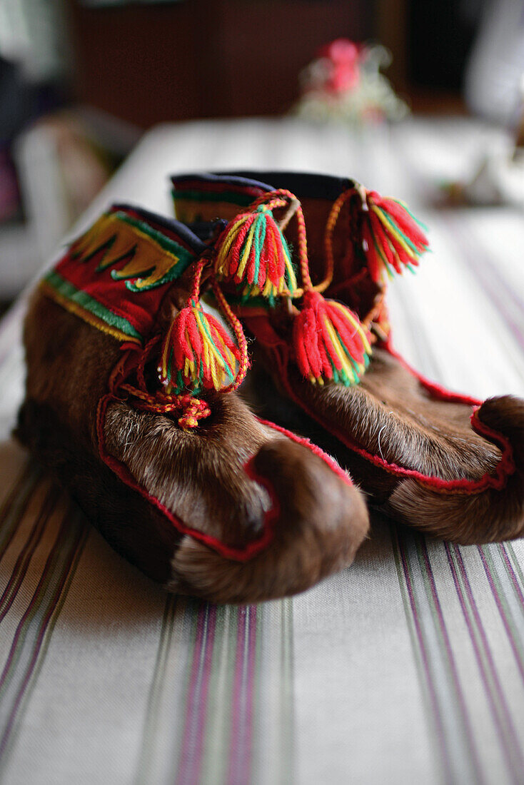 Traditional furry S?mi handmade shoes. Inside the home of Tuula Airamo, a S?mi descendant, and Reindeer farmer, by Muttus Lake. Inari, Lapland, Finland