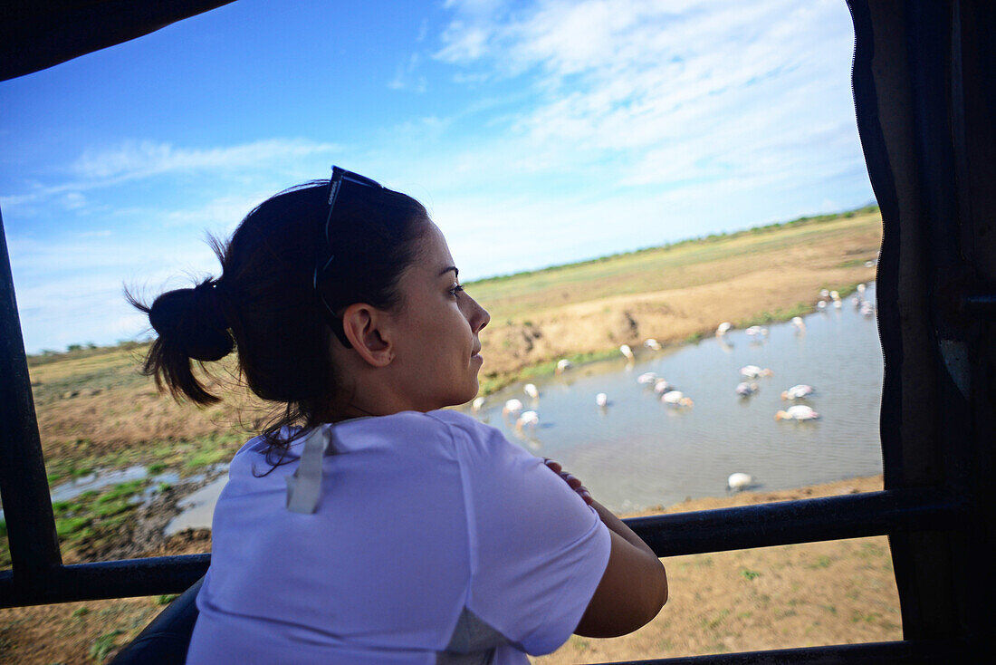 Young woman on safari jeep at Udawalawe National Park, Sri Lanka