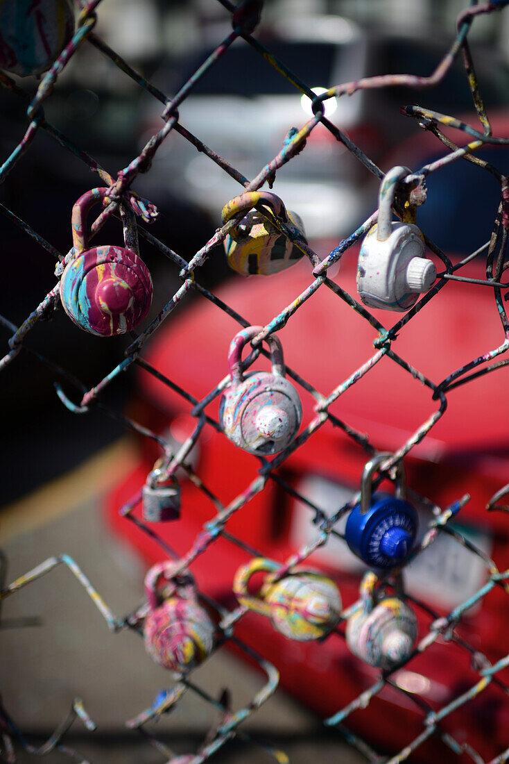 Painted padlocks on parking fence of Market Street, San Francisco