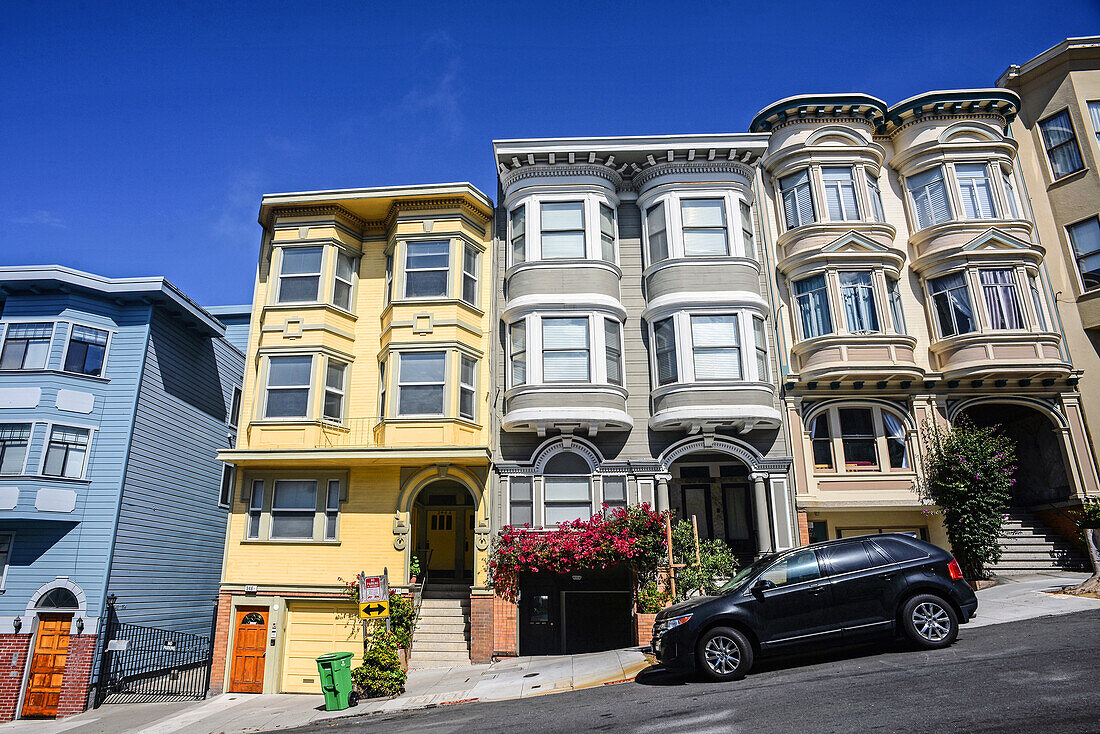 Car parked in front of house apartments in a steep street of San Francisco