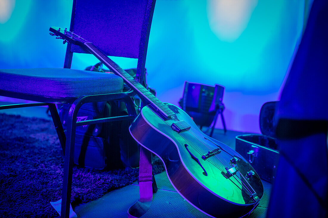Blue guitar resting against a chair in New Orleands