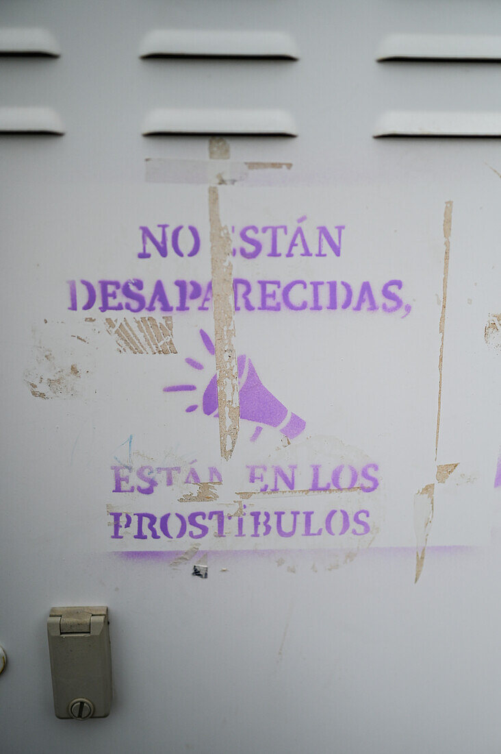 Wall painting reads "They are not missing, they are in the brothels"
