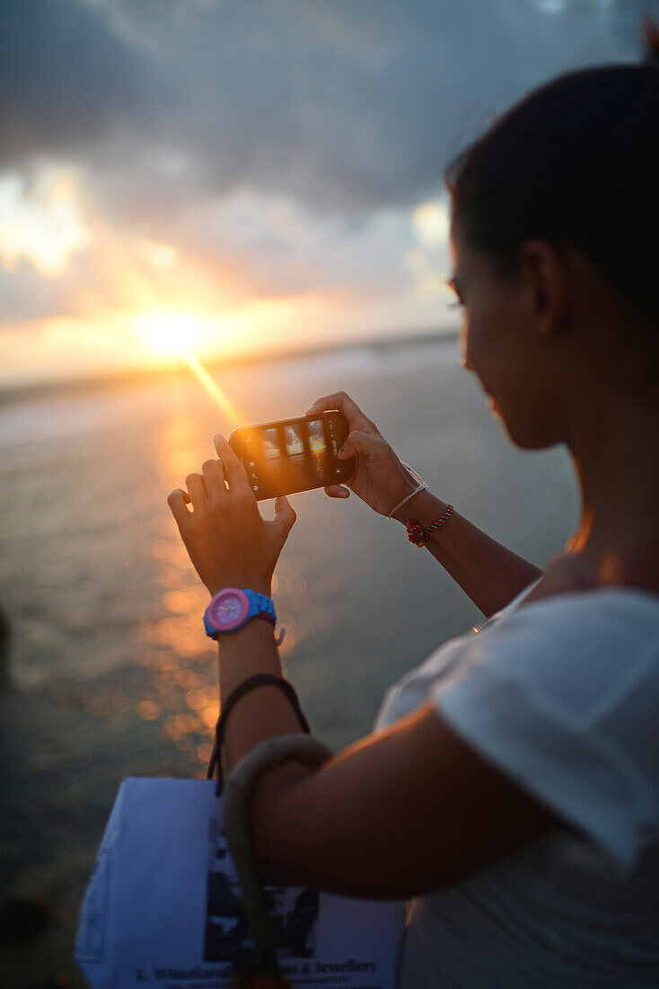 Young woman takes photo with mobile phone in Galle Fort, Old Town of Galle, UNESCO World Heritage Site, Sri Lanka