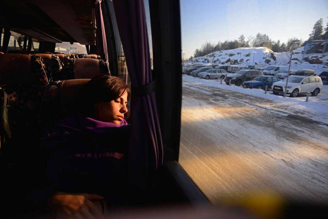 Junge Frau, die mit dem Bus zum Skigebiet Pyh? fährt, Lappland, Finnland