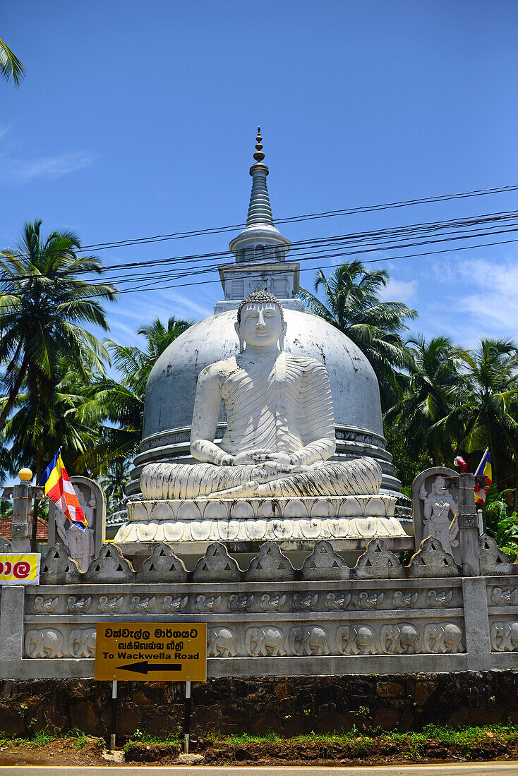 Sitting Buddha and stupa in Galle, Sri Lanka