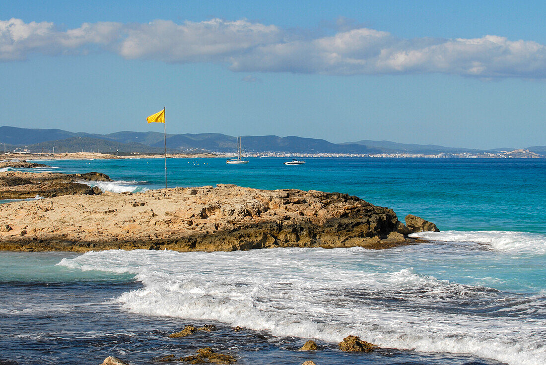 Strong sea and yellow flag in Levante beach - Playa de Llevant -, Formentera