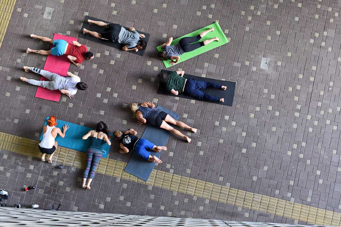 Group of people practice acroyoga outside the Museum of Modern Art of Medellin (MAMM), Colombia