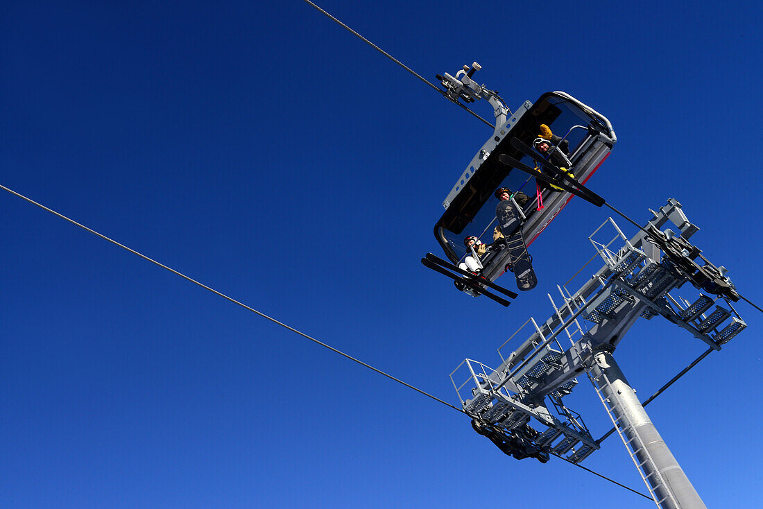 Skiers say hi from chair lift. Pyh? Ski Resort in Lapland, Finland