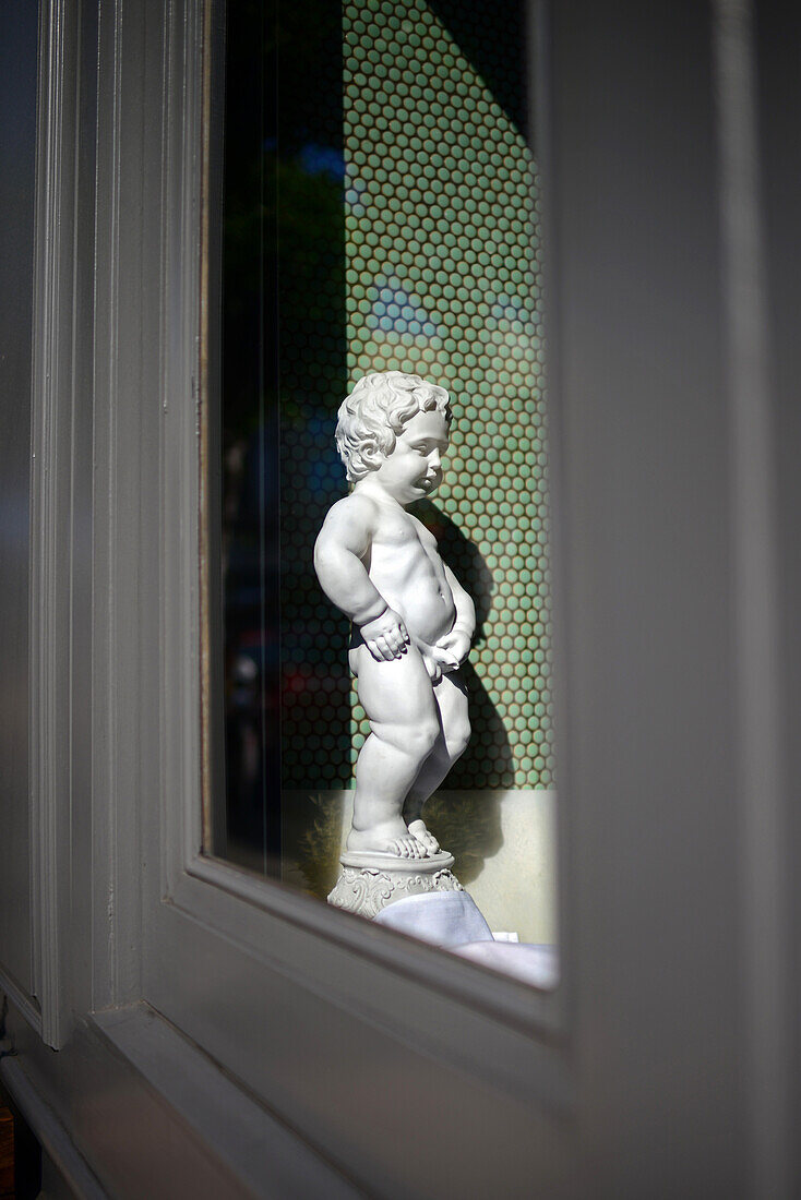 Replica of popular Manneken Pis sculpture in restaurant. San Francisco, California.