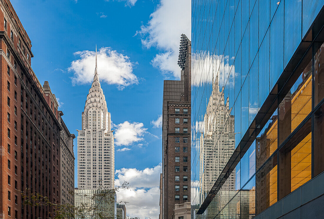 The Chrysler Building reflected on a glass building on 42th street