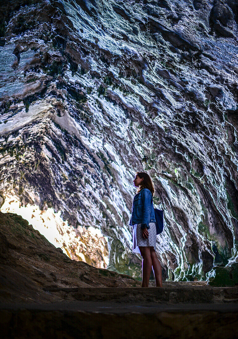 Young woman in Caves of Artà (Coves d’Artà) in the municipality of Capdepera, in the Northeast of the island of Mallorca, Spain