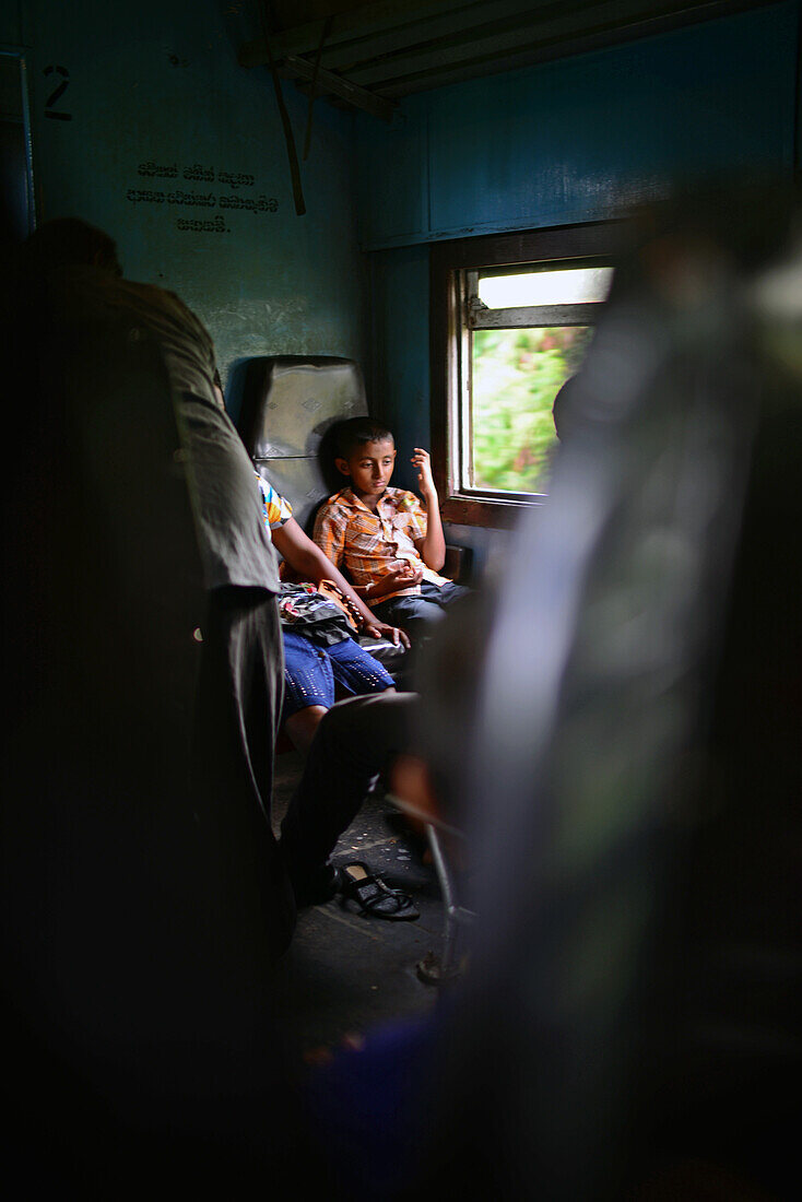 Young boy with her mother in train, Sri Lanka