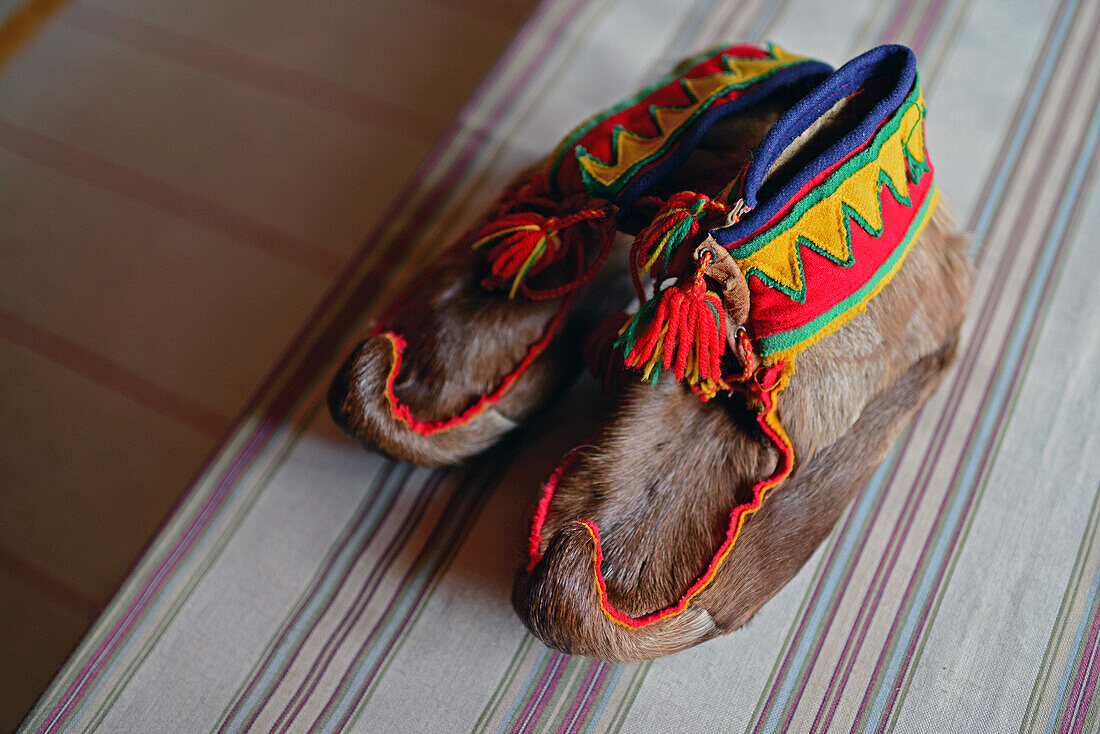 Traditional furry S?mi handmade shoes. Inside the home of Tuula Airamo, a S?mi descendant, and Reindeer farmer, by Muttus Lake. Inari, Lapland, Finland