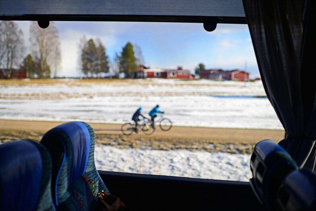 Kids riding bicycles in Lapland countryside