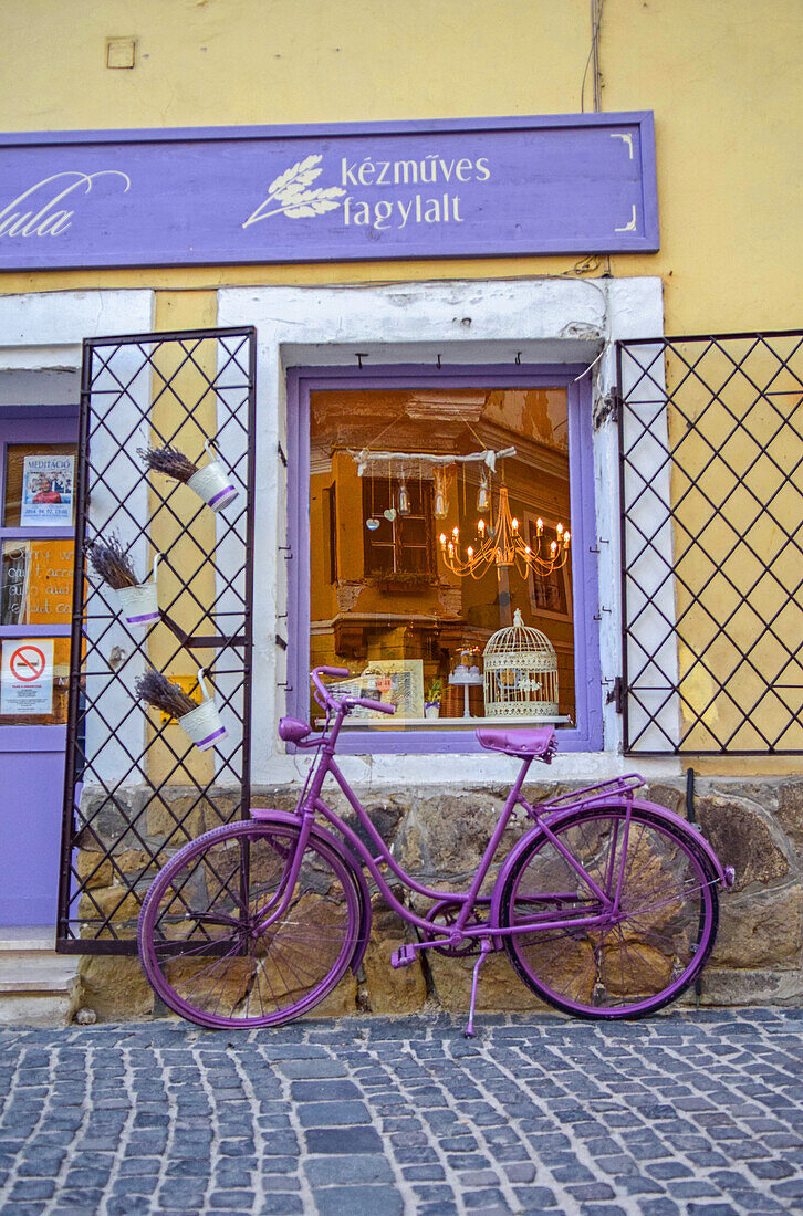 Purple bicycle decorates ice cream shop in the streets of Szentendre, a riverside town in Pest County, Hungary,