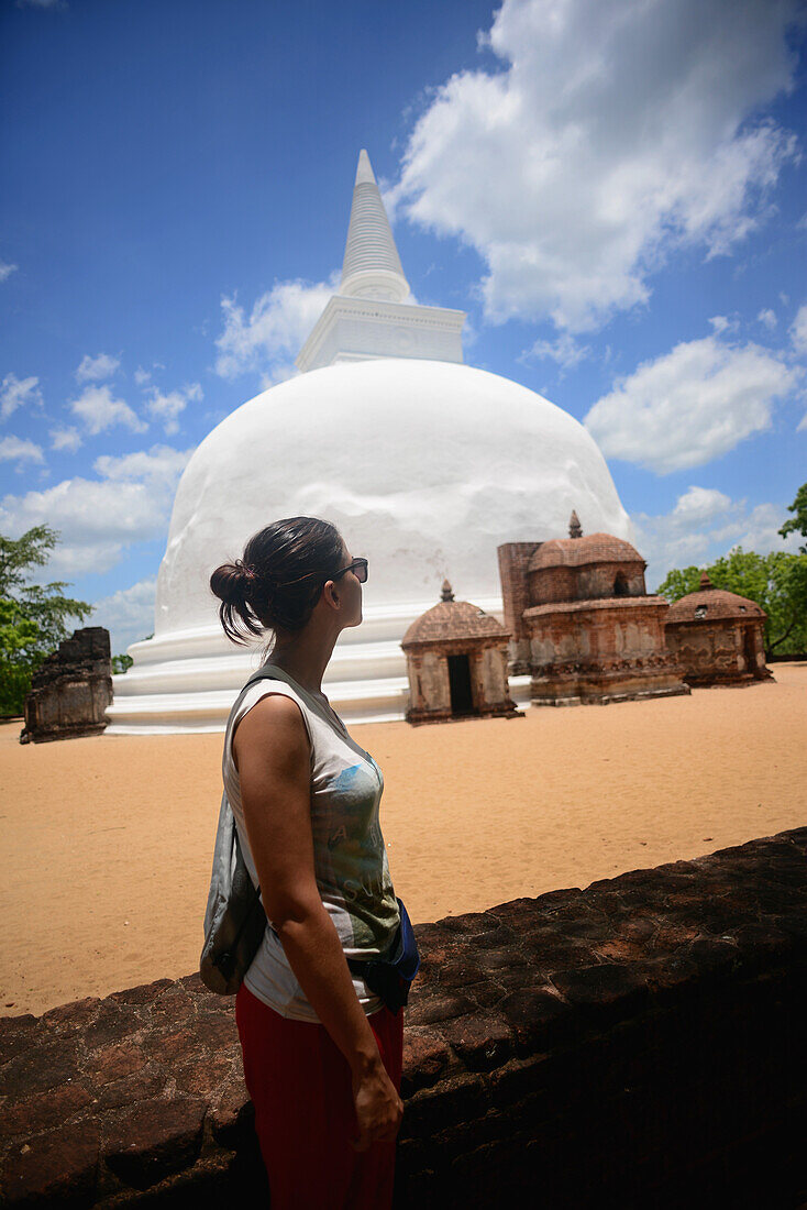 Young woman and Dagaba Kiri Vihara, built in honour of the king`s queen, in The Ancient City Polonnaruwa, Sri Lanka