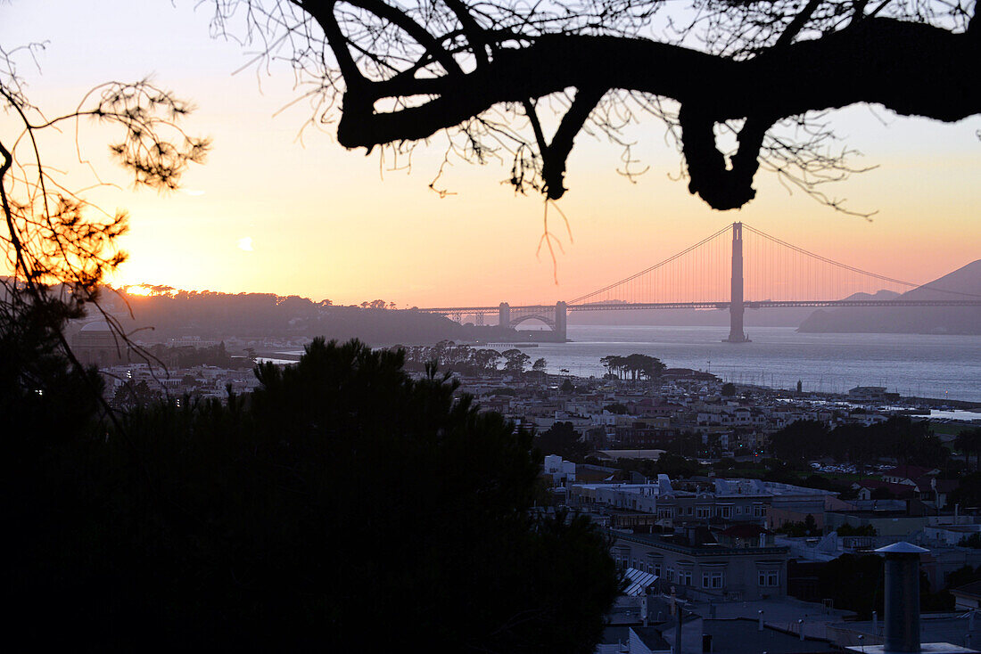 View of San Francisco and Golden Gate Bridge at sunset.