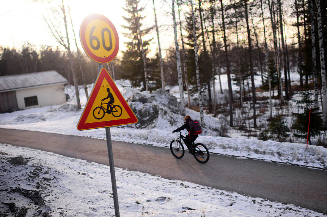 Kid riding bicycle in Lapland village