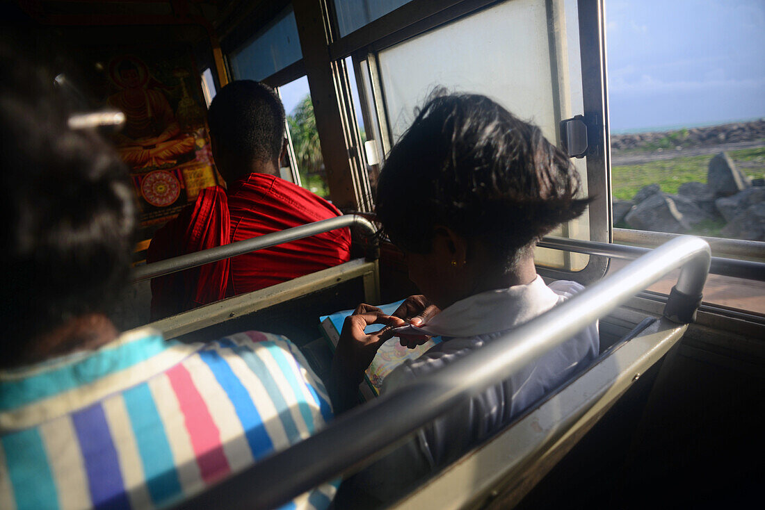 Young girl and Buddhist monk on bus, Sri Lanka