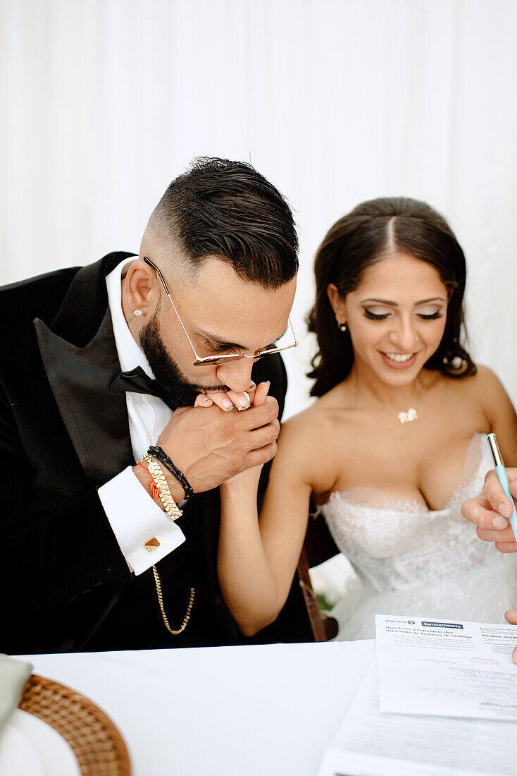 Bride and groom signing their marriage certificate