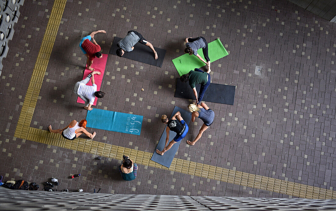Eine Gruppe von Menschen praktiziert Acroyoga vor dem Museum für moderne Kunst in Medellin (MAMM), Kolumbien