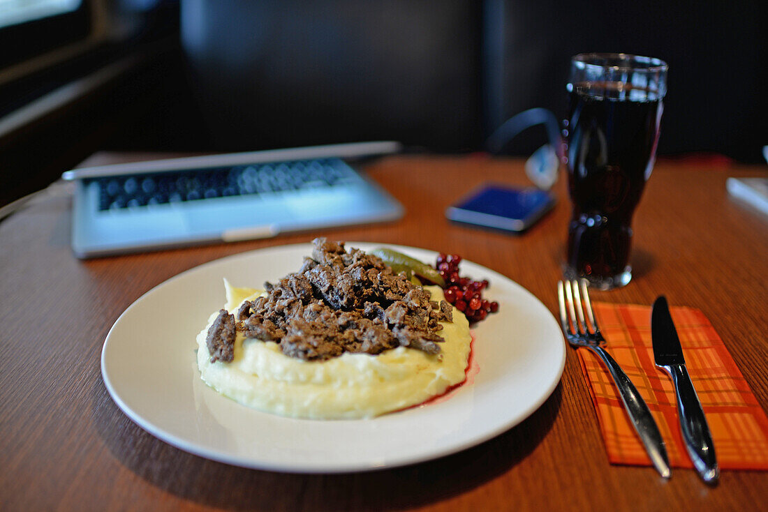 Reindeer meat on mashed potatoes with berries. Hotel Inari, Lapland, Finland.