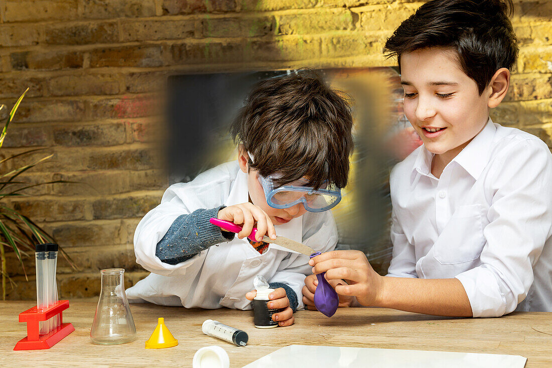 UK, Boys (4-5, 10-11) making science experiments at home