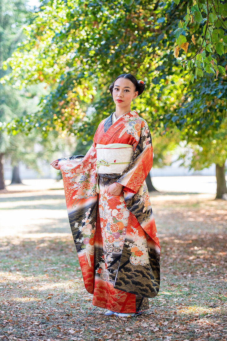Woman in kimono posing in park