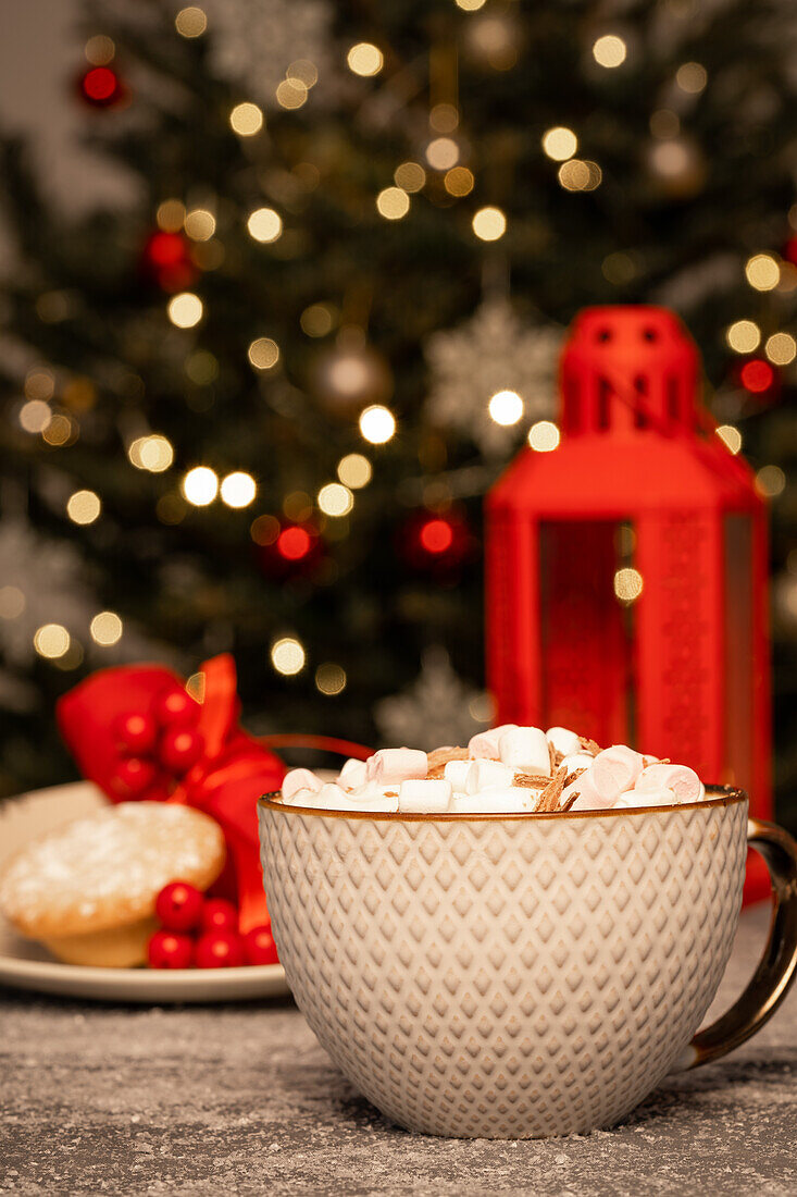 Hot chocolate with marshmallows in front of Christmas tree