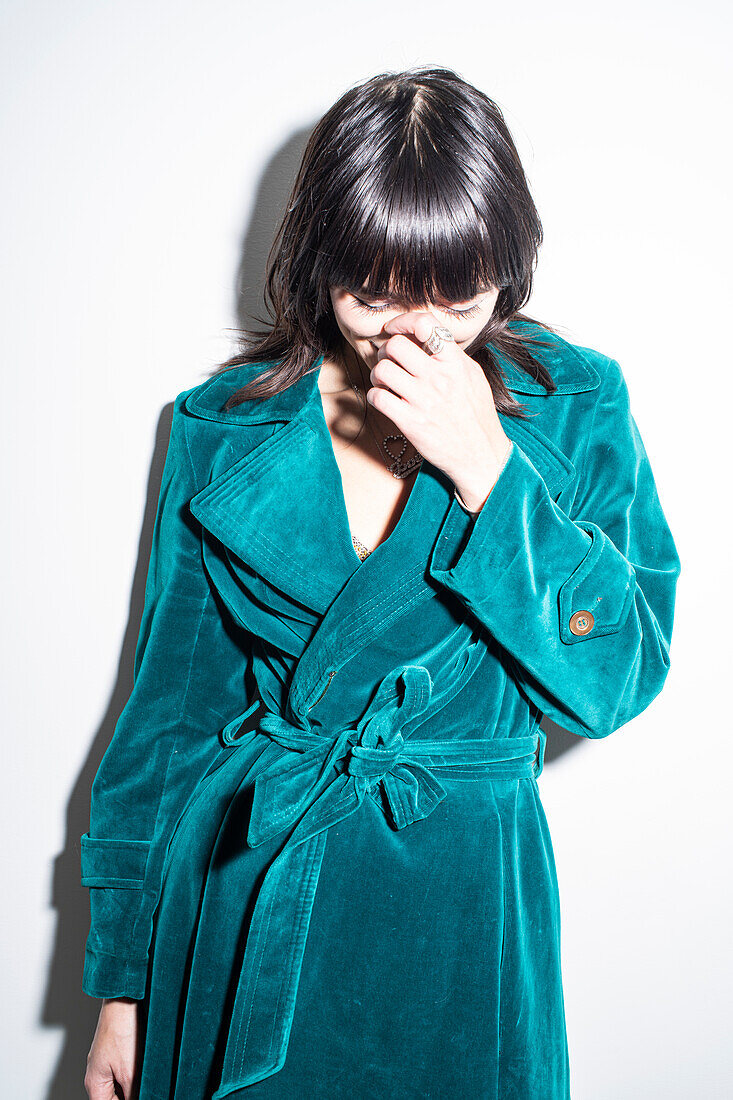 Studio shot of woman in blue coat