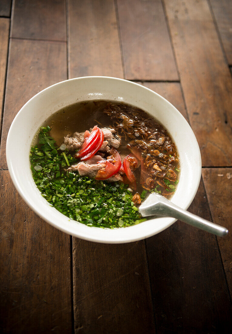 Laos, Vang Vieng, Traditional soup on table in restaurant